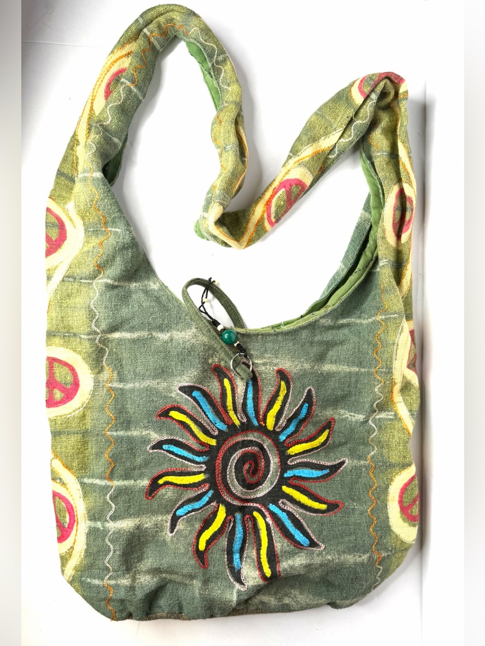 hobo bag with embroidered sun tote and a unique beaded zipper closure.